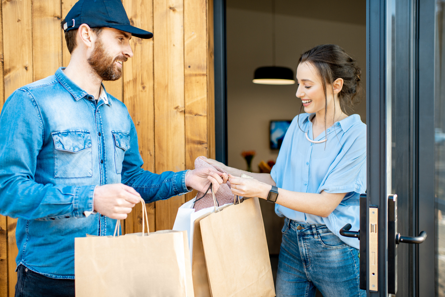 Delivery Man Bringing Goods Home for a Woman Client